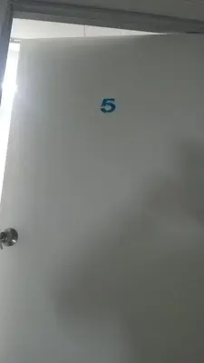 a white door with a logo on the side of it at Cool memories smart stay in Tanah Rata