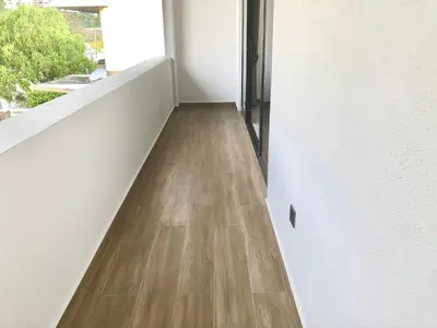a hallway with wood floors and a white wall at BigLanded House NR Penang Hill & Kek Lok Si Temple in Ayer Itam