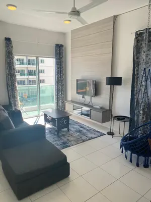 a living room with a couch and a tv at Qaseh Homestay Cameron Highlands The Quintet Apartment Tanah Rata in Tanah Rata