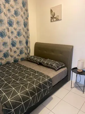a bedroom with a bed and a table and curtains at Qaseh Homestay Cameron Highlands The Quintet Apartment Tanah Rata in Tanah Rata