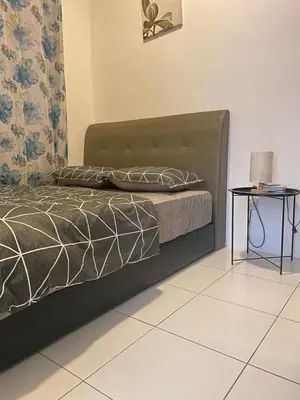 a bedroom with a bed and a side table at Qaseh Homestay Cameron Highlands The Quintet Apartment Tanah Rata in Tanah Rata