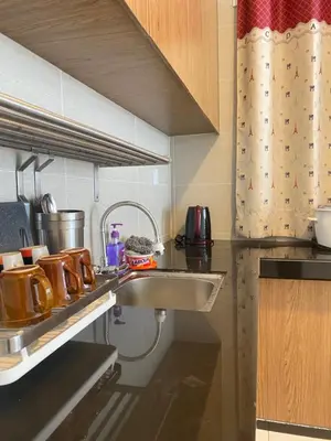 a kitchen with a sink and a counter top at Qaseh Homestay Cameron Highlands The Quintet Apartment Tanah Rata in Tanah Rata