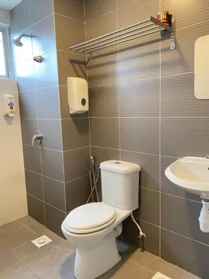 a bathroom with a toilet and a sink at Qaseh Homestay Cameron Highlands The Quintet Apartment Tanah Rata in Tanah Rata