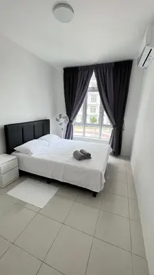 a bedroom with a bed and a large window at ANAS Homestay in Ipoh