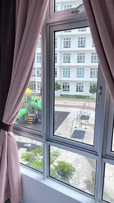 a window with a view of a playground at ANAS Homestay in Ipoh