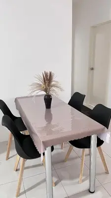 a dining room table with a vase on top of it at ANAS Homestay in Ipoh