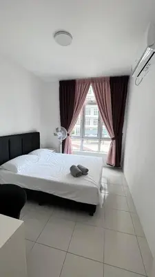 a bedroom with a bed and a window at ANAS Homestay in Ipoh