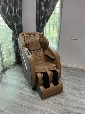 a brown reclining chair in a room with windows at Ss homestay in Seri Manjung