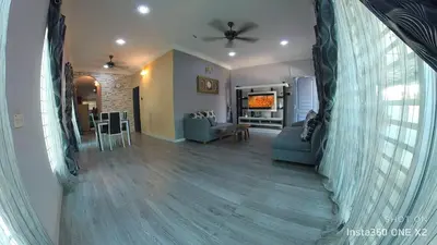 a living room with a couch and a dining room at Ss homestay in Seri Manjung