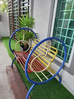 two colorful benches sitting next to a window at Ss homestay in Seri Manjung