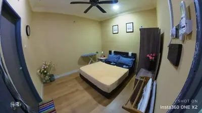 a bedroom with a bed and a ceiling fan at Ss homestay in Seri Manjung
