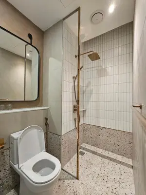 a bathroom with a toilet and a shower at Swettenham Room at Weld Quay Georgetown in George Town