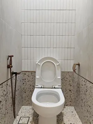 a bathroom with a toilet with the lid up at Swettenham Room at Weld Quay Georgetown in George Town