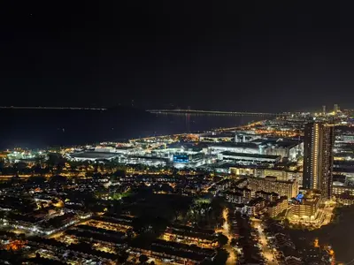 a view of a city at night with a bridge at LS Iconic Regency #Queensbay Mall#FIZ#Airport in Bayan Lepas