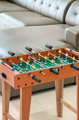 a coffee table with a foosball game on it at Taiping Peaceful Retreat near Lake Garden with WiFi in Taiping