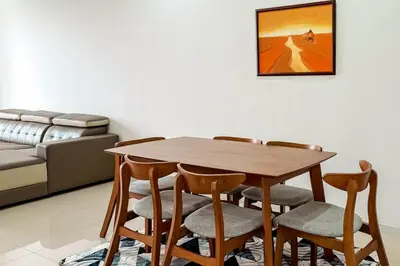 a dining room table with chairs and a couch at Taiping Peaceful Retreat near Lake Garden with WiFi in Taiping