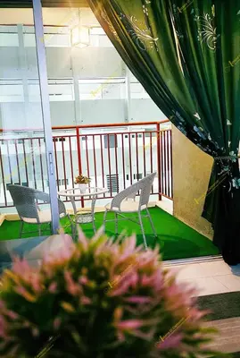 a balcony with chairs and a table on a balcony at Astana D'Cameron Homestay in Brinchang