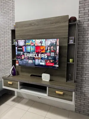 a entertainment center with a flat screen tv at AYAAN HOMESTAY HILL VIEW INN 2 FREE Wifi and Netflix in Cameron Highlands