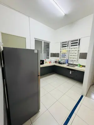 a kitchen with a refrigerator in the middle of a room at AYAAN HOMESTAY HILL VIEW INN 2 FREE Wifi and Netflix in Cameron Highlands