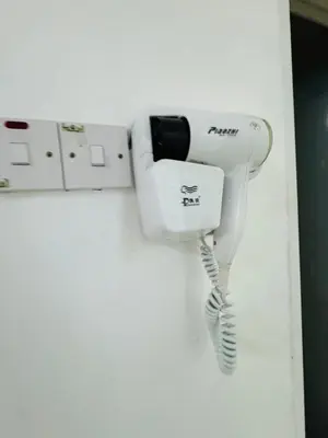 a hair dryer is hanging on a wall at AYAAN HOMESTAY HILL VIEW INN 2 FREE Wifi and Netflix in Cameron Highlands