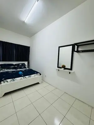 a bedroom with a bed and a mirror on the wall at AYAAN HOMESTAY HILL VIEW INN 2 FREE Wifi and Netflix in Cameron Highlands