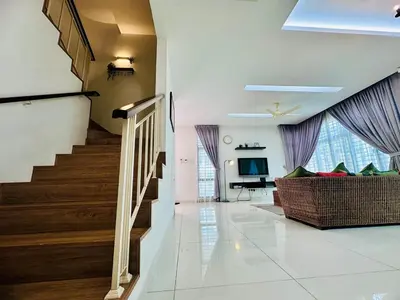 a living room with a staircase and a couch at New Sea Breeze Landed Home 13pax BatuFerrigghi in Batu Ferringhi