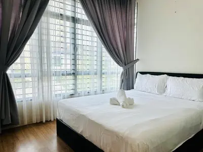 a bedroom with a bed with white sheets and a large window at New Sea Breeze Landed Home 13pax BatuFerrigghi in Batu Ferringhi