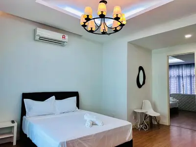 a bedroom with a white bed and a chandelier at New Sea Breeze Landed Home 13pax BatuFerrigghi in Batu Ferringhi