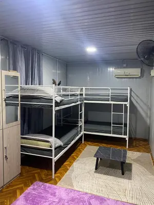 a room with two bunk beds and a rug at Kabinstay suasana dusun in Kampung Lubuk Buaya
