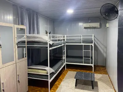 a room with two bunk beds in a room at Kabinstay suasana dusun in Kampung Lubuk Buaya