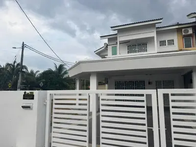 a white fence in front of a house at RK Homestay in Seri Manjung