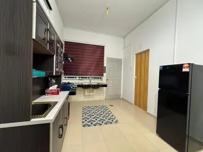 a kitchen with a black refrigerator and a tile floor at RK Homestay in Seri Manjung