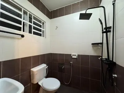a bathroom with a shower with a toilet and a sink at RK Homestay in Seri Manjung