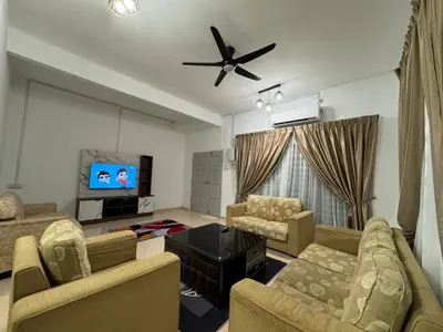 a living room with two couches and a flat screen tv at RK Homestay in Seri Manjung