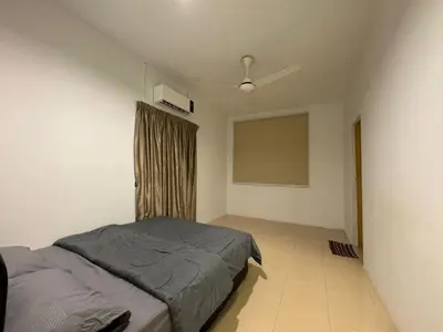 a bedroom with a bed and a ceiling fan at RK Homestay in Seri Manjung
