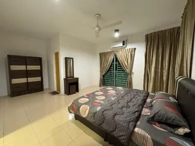 a bedroom with a bed and a window at RK Homestay in Seri Manjung