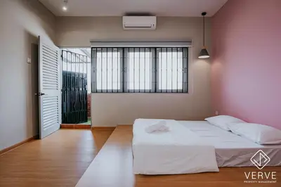 a bedroom with a white bed and a window at The Time Capsule 4B3B BY Verve 12 Pax in Ipoh