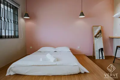 a large white bed in a room with pink walls at The Time Capsule 4B3B BY Verve 12 Pax in Ipoh