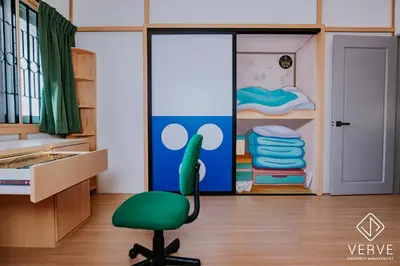 a green chair in a room with a bedroom at The Time Capsule 4B3B BY Verve 12 Pax in Ipoh