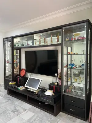 a entertainment center with a television and glass shelves at KKB Gathering Home - ENTIRE HOME in Kuala Kubu Baharu