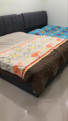 a bed with a comforter with flowers on it at KKB Gathering Home - ENTIRE HOME in Kuala Kubu Baharu