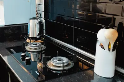 a kitchen counter with a stove with a mortar and pestle at S&A Homestay in Sungai Petani