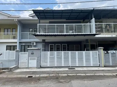 a house with a white fence in front of it at Ariela Homestay in Ipoh