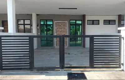 a gate in front of a house with windows at D'SARRA Homestay Nibong Tebal in Nibung Tebal