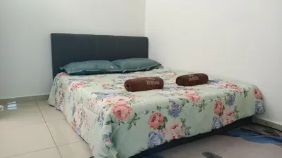 a bed with two pillows on top of it at D'SARRA Homestay Nibong Tebal in Nibung Tebal