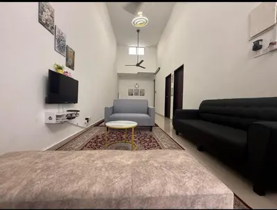 a living room with a couch and a table at D'SARRA Homestay Nibong Tebal in Nibung Tebal