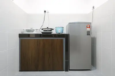 a kitchen with a counter with a refrigerator at Elegant Studio Escape at Emerald Avenue Brinchang Cameron Highland Clover Home 4-03 in Brinchang
