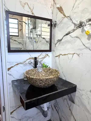 a bathroom with a bowl sink on a black counter at Canning Garden-The Ipohscape in Ipoh