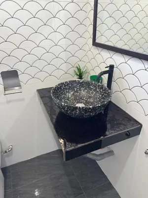 a bathroom with a sink on a black counter at Canning Garden-The Ipohscape in Ipoh