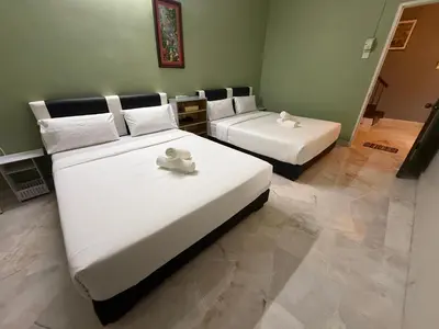 a bedroom with two beds with towels on them at Canning Garden-The Ipohscape in Ipoh